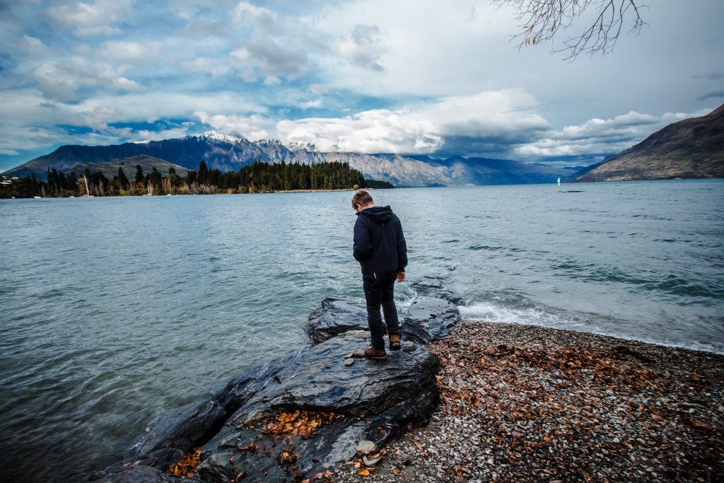 Men standing at the edge of a lake