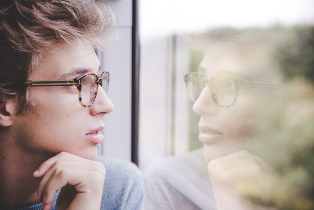 Men looking at window thinking